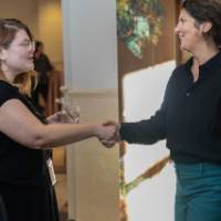 Two people shaking hands at event